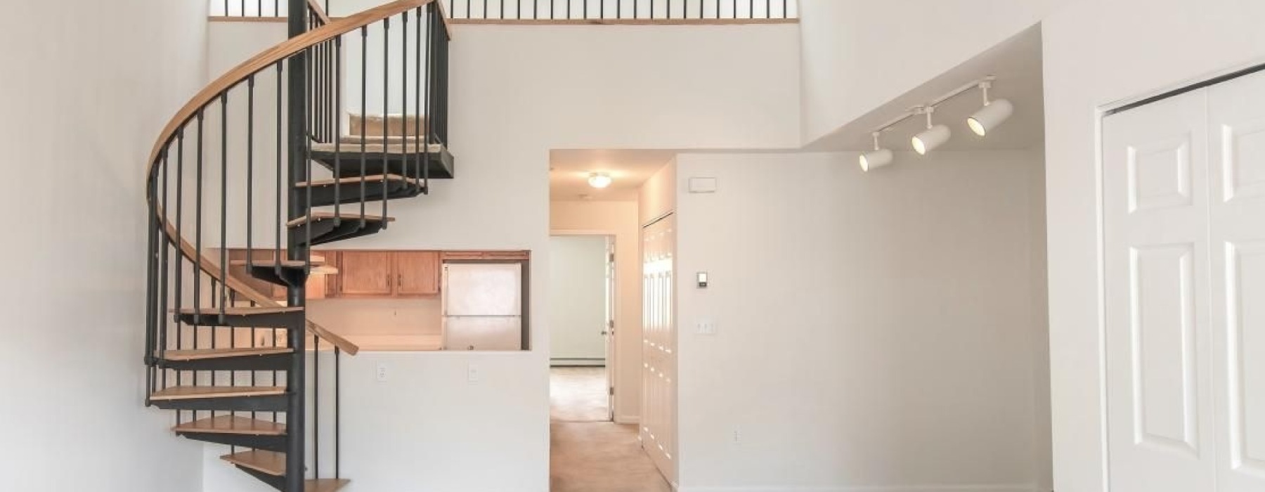 bright bottom floor with spiral steps
