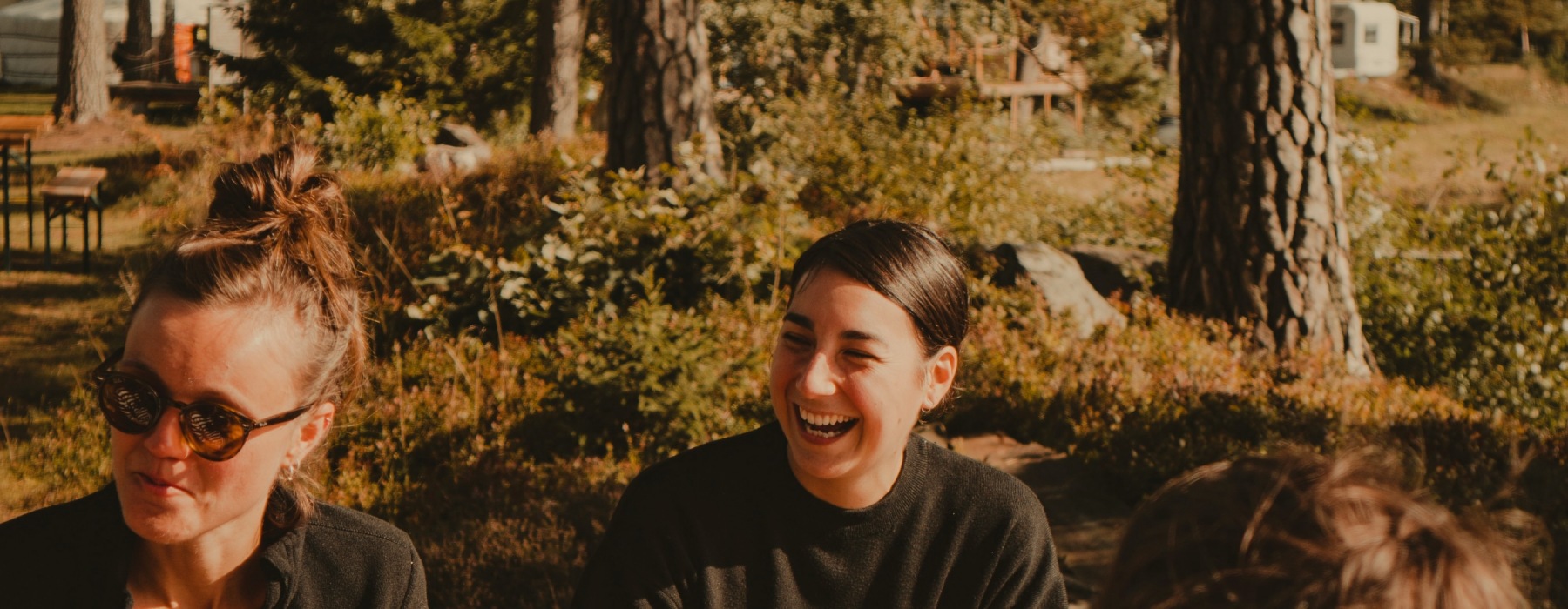 a couple of people laughing outdoors