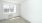 an empty bed room with large window 